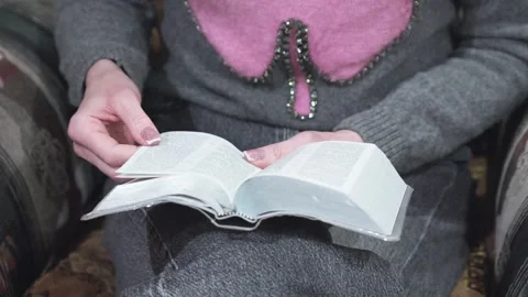 Close-up of a woman's hands flipping through Bible pages Stock Footage 306728897