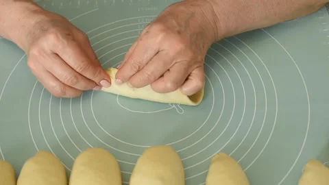 Close-up of a woman's hands forming a pie from dough. Stock Footage 250466590