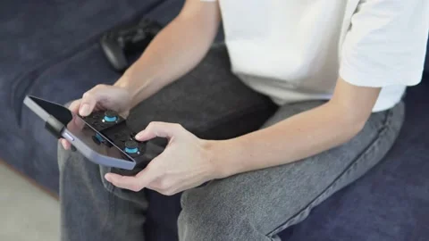 Close-up of a woman's hands with a game joystick and a phone Stock Footage 231901249