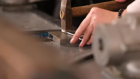 Close-up of a woman's hands hammering a piece of wood. Stock Footage 329178149