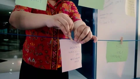 Close-up of a woman's hands hanging paper on a string Stock Footage 270197731
