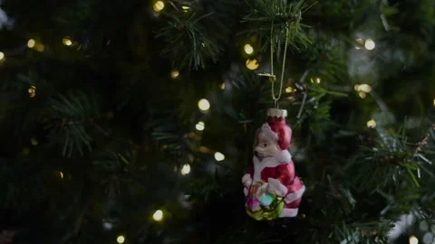 Close up of woman's hands hanging a red Christmas tree ornament in the shape of Stock Footage 164567196