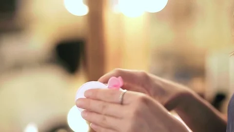 Close up of woman's hands holding makeup remover in slow motion Stock Footage 76081077