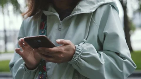 Close-up of a woman's hands holding a smartphone and typing a message on the Stock Footage 221965373
