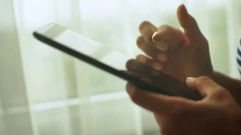 Close up of woman`s hands holding tablet in her hands, while relaxing at home Stock Footage 73814773