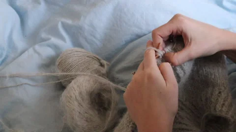 Close-Up of Womans Hands Knitting with Soft Wool Yarn Sustainable Fashion Stock Footage 301530661
