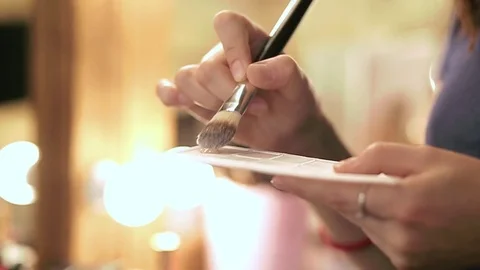 Close up of woman's hands with makeup foundation and brush in slow motion Stock Footage 76081407