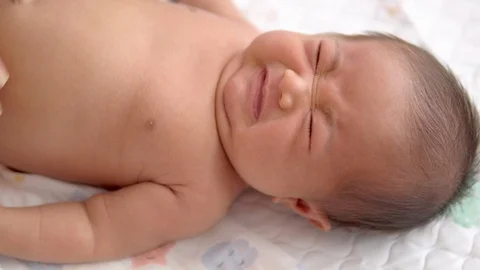 Close up Woman's hands making stomach massage of her newborn baby. Video stock 109143402