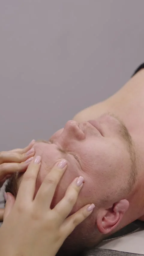 Close up of a woman's hands massaging a man's forehead Stock Footage 331460919