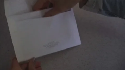Close-up of woman's hands opening the envelope with plane ticket and letter Stock Footage 101840459