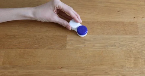 Close Up of woman's hands opens a plastic container with blue colored contact Stock-Footage 128134243