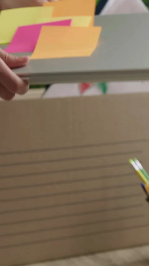 Close-up of a woman's hands packing up her personal belongings from an office to Stock Footage 305414532