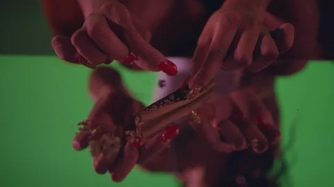 Close-up of a woman’s hands packing a marijuana joint Vídeo Stock 119090855