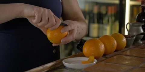 Close-up of woman's hands peeling an orange at a restaurant bar. Stock Footage 114194029