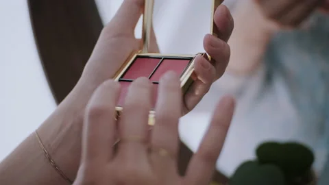 Close up of woman's hands picking colour from the eye shadow palette Video stock 132364097