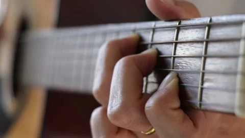 Close up woman's hands playing guitar in studio. Stock Footage 135590435