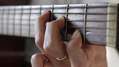 Close up woman's hands playing guitar in studio. Video stock 135590468