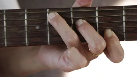 Close up woman's hands playing guitar in studio. Stock Footage 135590493