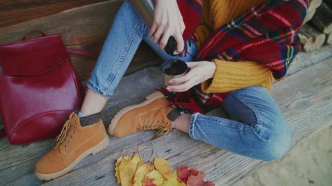 Close up of woman`s hands pours tea from thermos to cup. Young stylish tourist Stock Footage 114669397