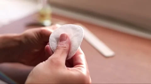 Close-up of woman's hands preparing a cotton pad on a table for beauty or p.. Stock Footage 333845552