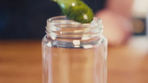 Close up of woman's hands preparing a green barley juice from powder using a jar Stock Footage 273510741