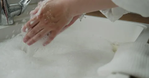 Close-up of woman's hands preparing kitchen sink for bathing a baby 動画素材 155807294