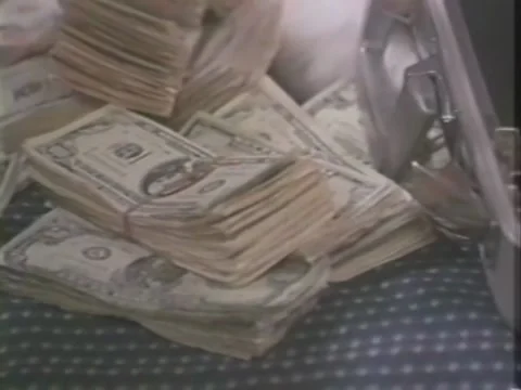 Close-up of woman's hands putting bundles of dollar bills into suitcase Stock-Footage 260258015