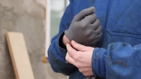 Close-up of a woman's hands putting on gray protective gloves Stock-Footage 334134837