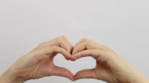 Close-up, woman's hands rise up making the heart symbol Stock Footage 144206452