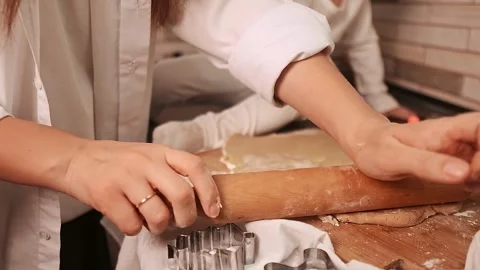 Close-up of a woman’s hands rolling dough for sweet gingerbread cookies Stock Footage 288450664