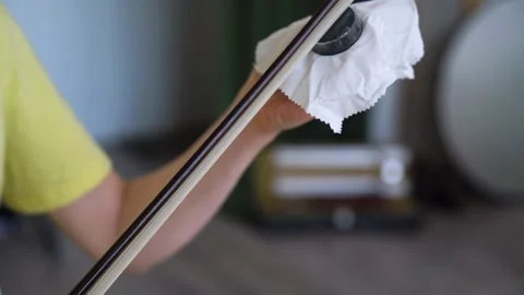 Close-up of Woman's Hands Rubbing The Rosin Onto Her Bow. Video stock 155107480