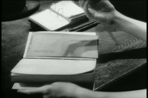 Close-up woman's hands searching through book Stock Footage