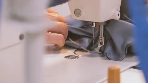 Close-up of woman's hands sewing on machine. Stock Footage 119176697