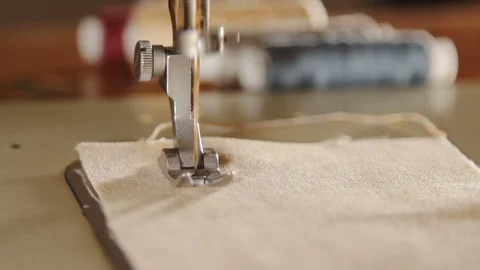 Close-up of woman's hands sewing an overlock at sewing machine. Tailor woman. Stock Footage 78772055