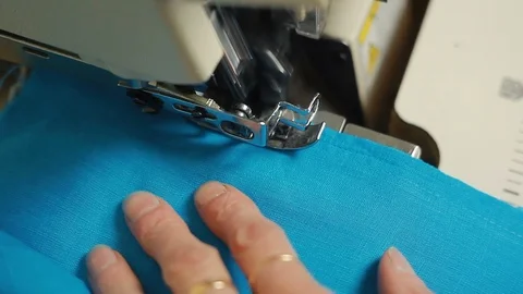 Close-up of woman's hands sewing an overlock at sewing machine. Stock-Footage 90804408