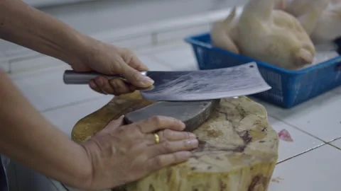 Close-up woman's hands sharpening a knife with a stone on a wooden table in the Video stock 276876719