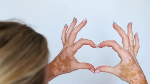 Close-up of a woman's hands showing a romantic gesture of love - a heart. Stock Footage 257440495