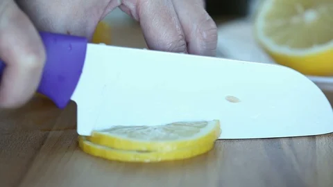 Close-up of the woman`s hands slising lemon. Stock Footage 91127375