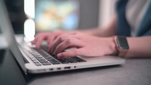 Close-up of woman's hands with smart watches using a laptop typing on a keyboard Stock Footage 145085586
