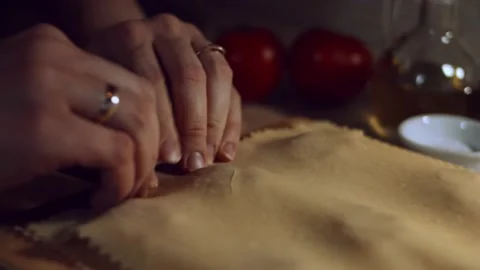 Close-up of woman's hands sticking the sheets of dough with meat filling inside Stock Footage 144829648