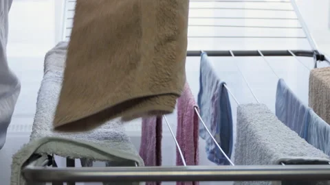 Close-up woman's hands take colored towels in the dryer and fold them. Drying Stock Footage 191580009