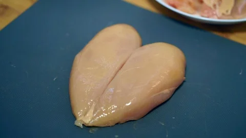 Close up, a woman's hands take a knife and cut the chicken Stock Footage 106759729