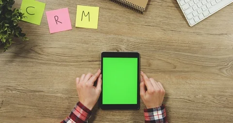 Close up on the woman's hands taping on the black vertical tablet device with a Video stock 89954964
