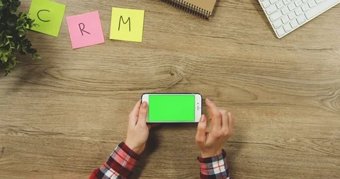 Close up on the woman's hands taping on the white horizontal smartphone with a Stock-Footage 89954727