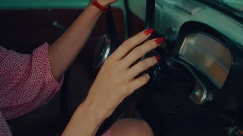 Close-up of a woman's hands touching the steering wheel of a retro car Stock Footage 246678853