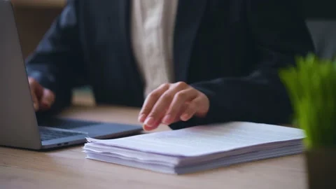 Close-up of a woman's hands typing, a boss threw documents on the table Video stock 233717564
