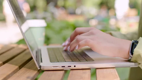 Close up of woman's hands typing on laptop computer keyboard and surfing the Stock Footage 205324811