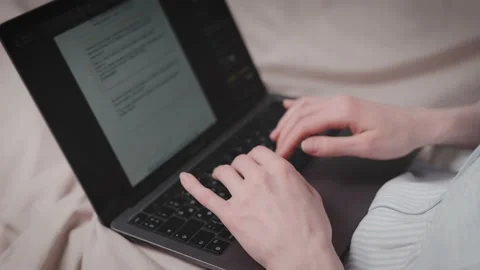 Close-up of a woman's hands typing on a laptop with an open document. Without a Stock Footage 237059837