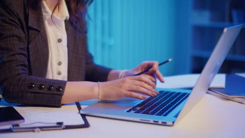 Close-up of a Womans Hands Typing on a Laptop in a Late-Night Office Stock Footage 289787602