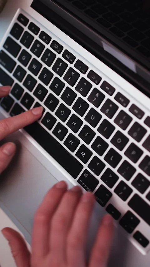 Close up of womans hands typing at laptop keyboard in office. Locked down close Stock Footage 303008513